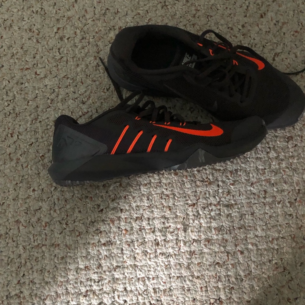 Gray Nike men’s sneakers with orange swoosh